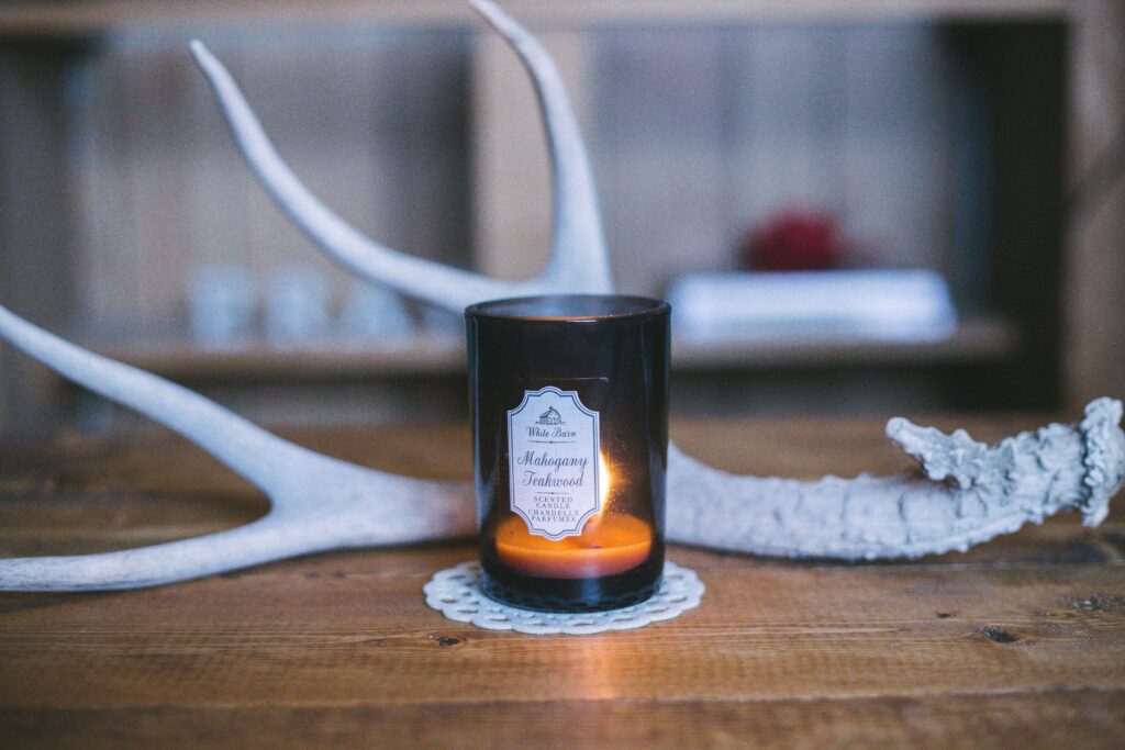 scented candle near deer horn
