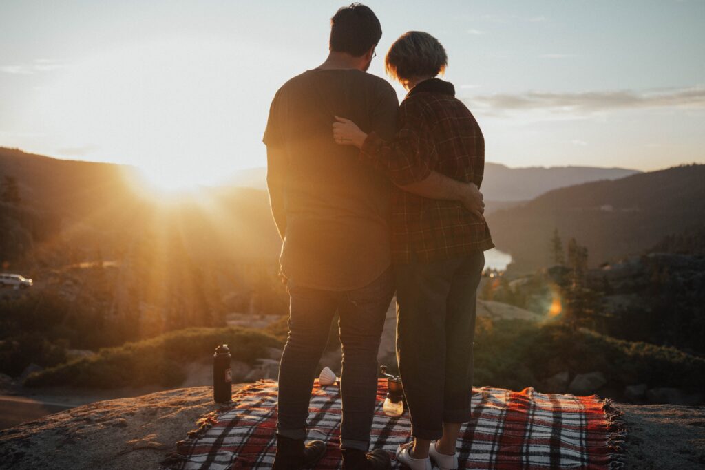 couple standing on top of mountain